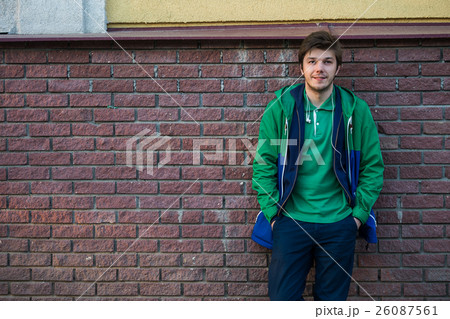 Common young man wearing green t-shirt jacket and 26087561
