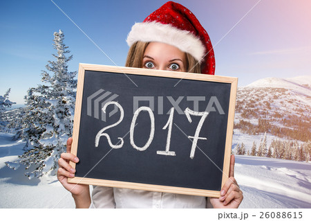 Cute girl in xmas hat with chalkboard Cute girl in xmas hat with chalkboard 26088615