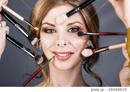 Many hands doing make up to glamour woman. 26088630