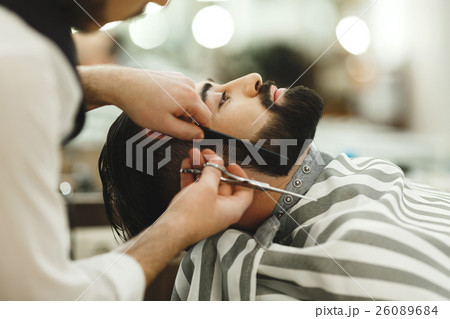 Barber making a beard Barber making a beard 26089684