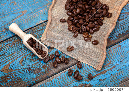 Coffee beans with a wooden scoop. Coffee beans with a wooden scoop. 26090074