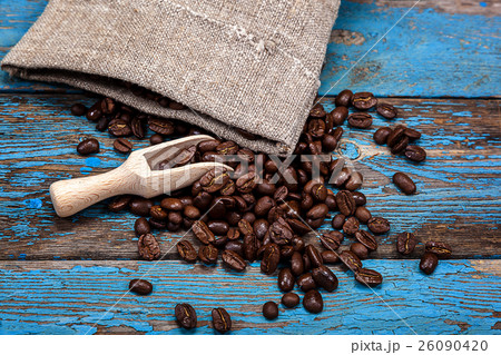 Coffee beans with a wooden scoop. Coffee beans with a wooden scoop. 26090420