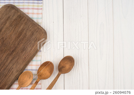 Cutting board and a spoon on old wooden tabl 26094076