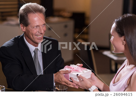 Smiling man giving a present to the woman 26094615