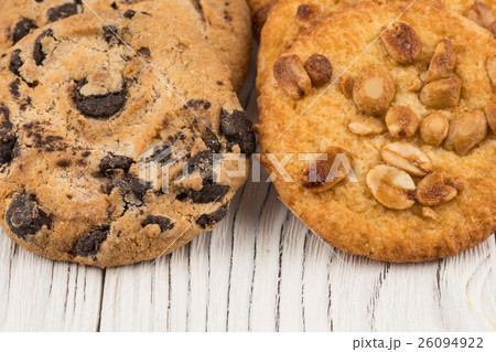 Biscuits with chocolate and peanut on table. Biscuits with chocolate and peanut on table. 26094922