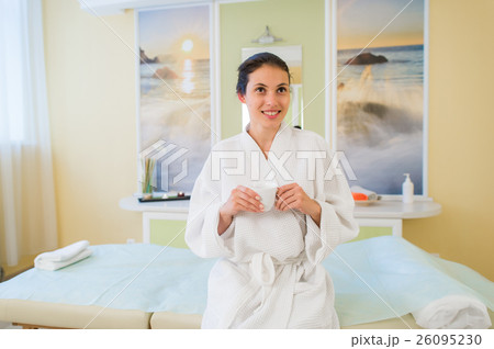 Pretty young Hispanic woman wearing a robe and Pretty young Hispanic woman wearing a robe and 26095230