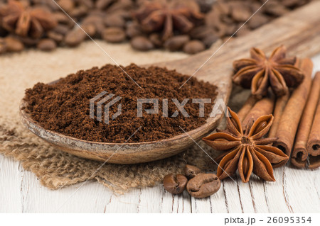 Ground coffee in a wooden spoon on wooden table. Ground coffee in a wooden spoon on wooden table. 26095354