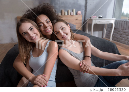 Smiling friends hugging in the bedroom at home Smiling friends hugging in the bedroom at home 26095520