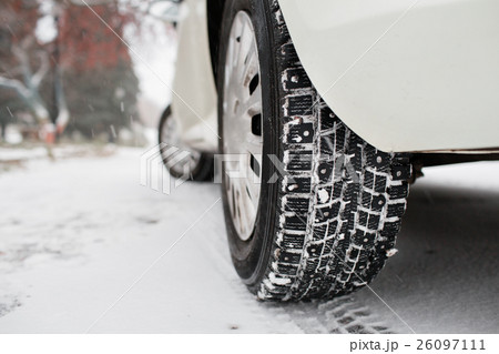 Closeup of car tires in winter. the first snow in Closeup of car tires in winter. the first snow in 26097111