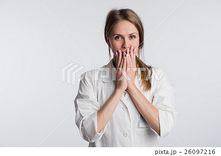 Young female doctor or nurse is shocked with hands Young female doctor or nurse is shocked with hands 26097216