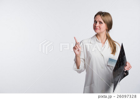 Doctor holding a X-ray and pointing to blank copy Doctor holding a X-ray and pointing to blank copy 26097328