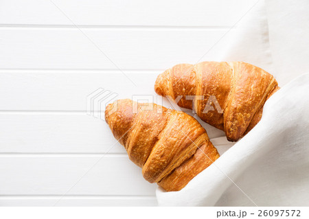 Tasty buttery croissants in napkin. 26097572