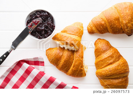 Tasty buttery croissant and jam in jar. Tasty buttery croissant and jam in jar. 26097573