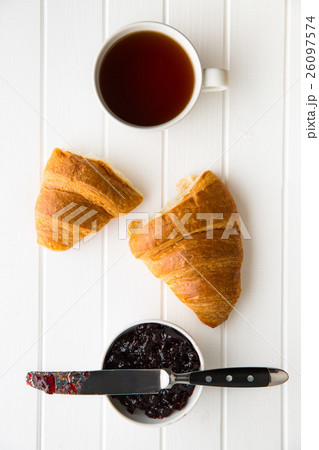 Tasty buttery croissant and jam in jar. Tasty buttery croissant and jam in jar. 26097574