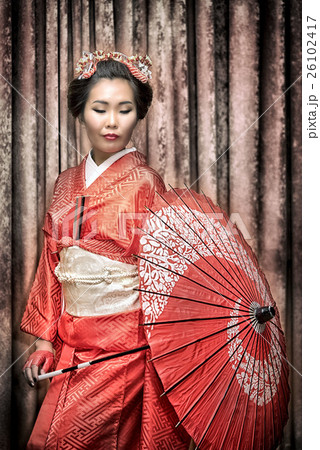 asian woman in traditional red kimono with parasol asian woman in traditional red kimono with parasol 26102417