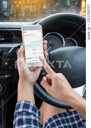 Young female driver using touch screen smartphone 26106052