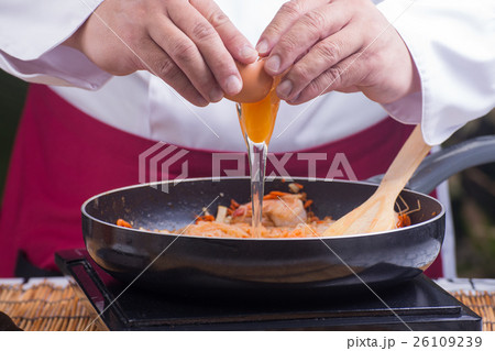 Chef putting egg for cooking Pad Thai Chef putting egg for cooking Pad Thai 26109239