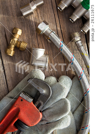 Set of plumbing and tools on the wooden table 26111675
