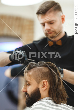 Barber doing haircuts for client Barber doing haircuts for client 26113076