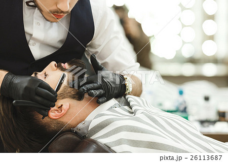 Hands in gloves making beard form 26113687