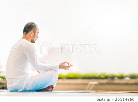 Young man meditating by swimming pool,yoga concept Young man meditating by swimming pool,yoga concept 26114860