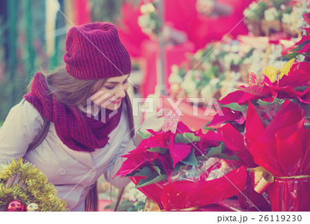 Pretty woman buying floral compositions at Christmas market Pretty woman buying floral compositions at Christmas market 26119230