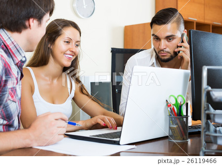 Group smile while using laptop 26119466