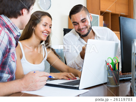 colleagues watching on laptop 26119703