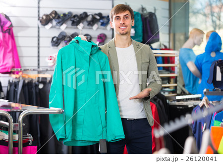 Man picking a cardigan in the sport shop Man picking a cardigan in the sport shop 26120041