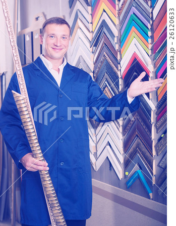 happy man seller in picture framing studio with wooden details happy man seller in picture framing studio with wooden details 26120633