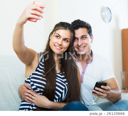 Couple hugging and doing selfie Couple hugging and doing selfie 26120666