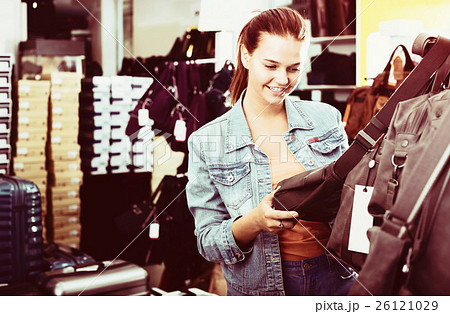 Girl buying handbag in fashion shop Girl buying handbag in fashion shop 26121029