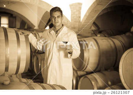 taster of winery posing with wine 26121307