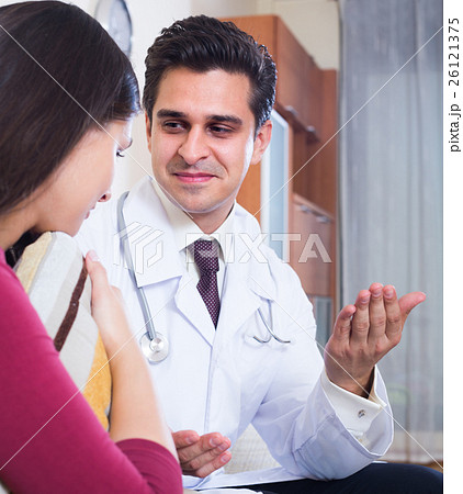 Positive physician consulting sick woman in domestic interior Positive physician consulting sick woman in domestic interior 26121375
