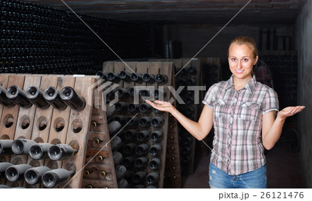 female wine maker in winery cellar. female wine maker in winery cellar. 26121476