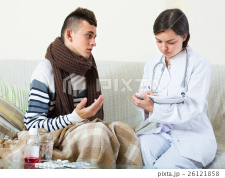Teenager and doctor at home. Teenager and doctor at home. 26121858