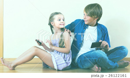 girl and boy burying in mobile phones 26122161