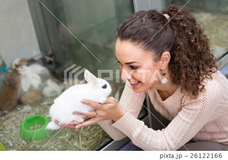 Girl holding the rabbit at pet shop. 26122166