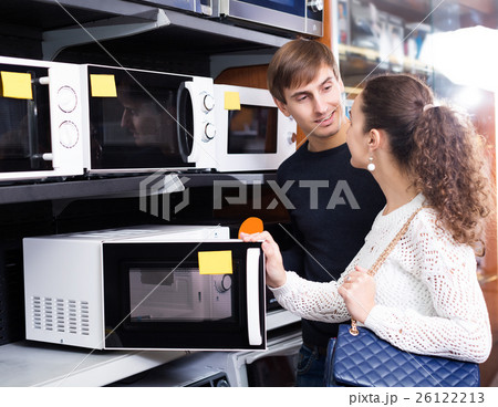 couple buying microwave oven in hypermarket and smiling 26122213