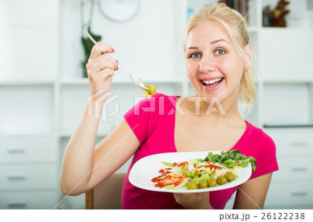 Portrait of glad blond girl eating salad Portrait of glad blond girl eating salad 26122238