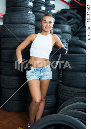 Adult girl working in car workshop 26122407