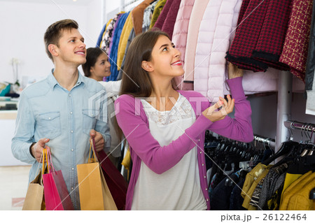 Cheerful couple holding shopping bags. Cheerful couple holding shopping bags. 26122464