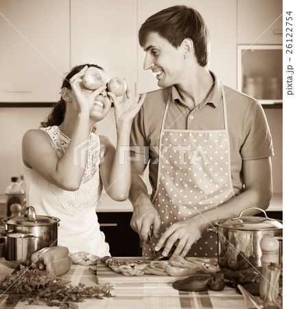 man and woman standing near table with vegetables man and woman standing near table with vegetables 26122754