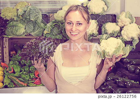 young woman buying cabbage at market. young woman buying cabbage at market. 26122756