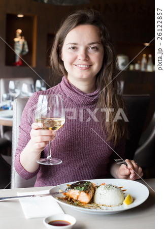 Woman spending her time in restaurant Woman spending her time in restaurant 26122857