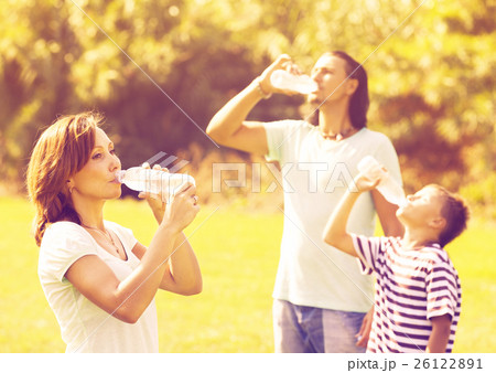 ordinary family of three drinking from bottles ordinary family of three drinking from bottles 26122891