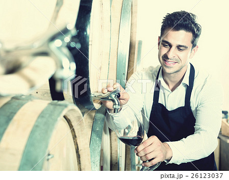 Seller pouring wine in cellar Seller pouring wine in cellar 26123037