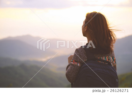 Hipster young girl with backpack enjoying sunrise Hipster young girl with backpack enjoying sunrise 26126271