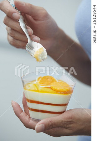 Woman eating fruit mousse 26129544