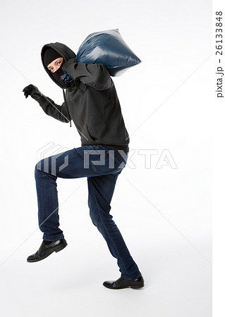 Thief in gloves with bag 26133848